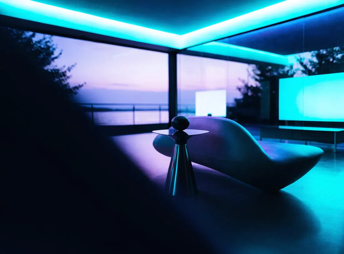 A modern direct-booking website glowing in a luxury vacation rental at dusk